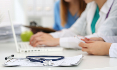 A doctor fills out a health insurance claim form