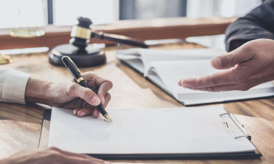 A solicitor helps a small business with the bridging loan application