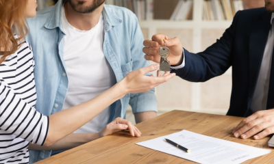 A young couple collect the keys from the landlord