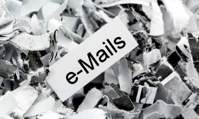 An email policy for your employees Black and white image of paper with e-mails written on it on background of shredded paper