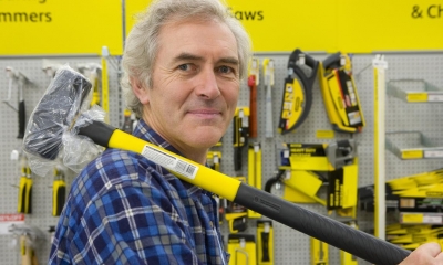 Customer holding building equipment in a tool shop