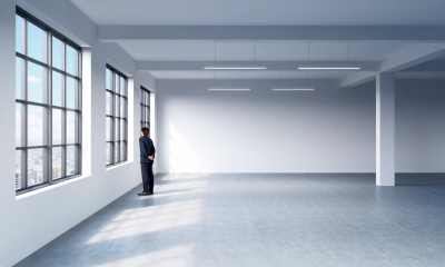 Commercial premises law A man looks out the window of an empty office space