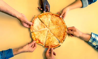 Multiple company employees equally share a cheese pizza