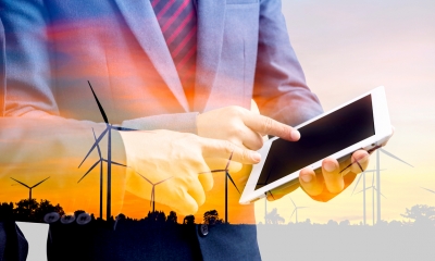 Conduct an environmental review A business man is carrying out an enviromental review and recording his findings