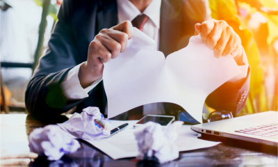 A business man tears up a contract in a commercial dispute
