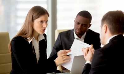 Group of shareholders in suits disputing a contract in a boardroom