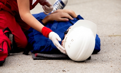 Dealing with an accident - checklist Worker injured at construction site beign cared for