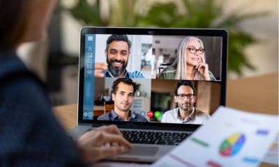 HR women using video conferencing tools on her grey laptop to check staff mental well being