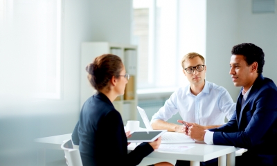 Group of workers in suits discussing an employment tribunal claim