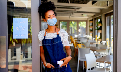 A small business owner waits for her staff to return