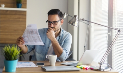 Man looking into business report