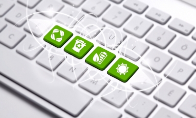 Go green and benefit your business Green environmental symbols on computer keyboard