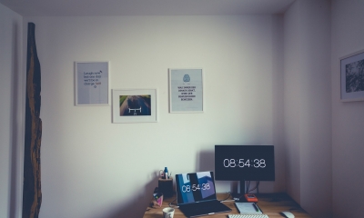 Working from home setup with digital clock on the screen display