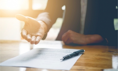 A lawyer presents legal documents to a client