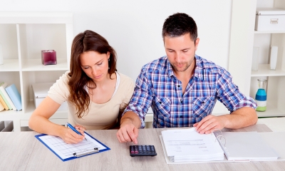 Two parents calculating their maternity pay