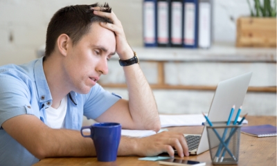 Freelancer on his laptop at his home desk - not eligible for support from the government