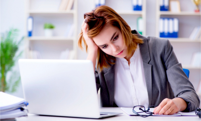 A worried female employee considers her options after being presented with a settlement agreement by her employer