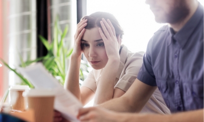 Businesswoman looking at documents with worry
