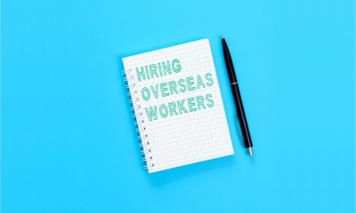 Notepad with the words 'Hiring overseas workers' written on it