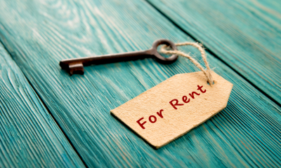 An old key with a "For rent" tag