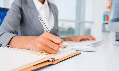 Woman signing business sale contract