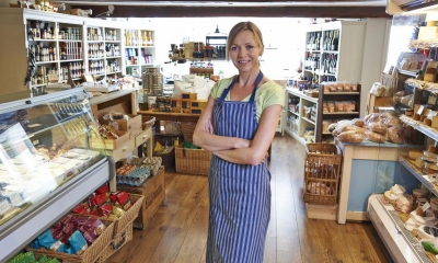 Woman in blue and white striped apron in delicatessen
