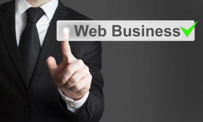 Man in black suit pointing to piece of text in front of him