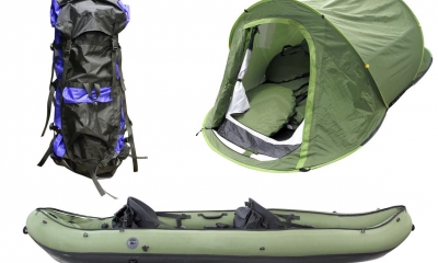 Large backpack, tent, and blow up canoe with white background