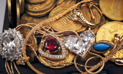 Multiple pieces of jewellery on top of gold coins