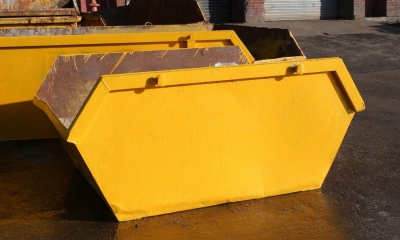Yellow skips on road outside garages