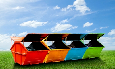 Reduce pollution and waste Large multi-coloured waste skips in a row