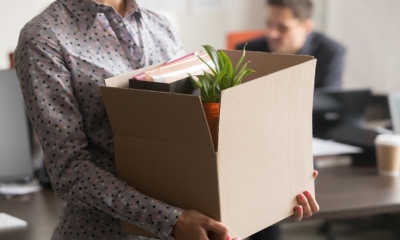 A female employee clears her desk after being made redundant