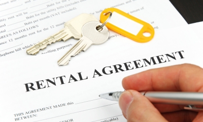 Rent reviews Hand holding pen signing rental agreement