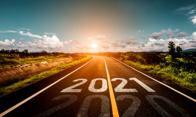 A road heading towards the sunrise with 2021 written on it