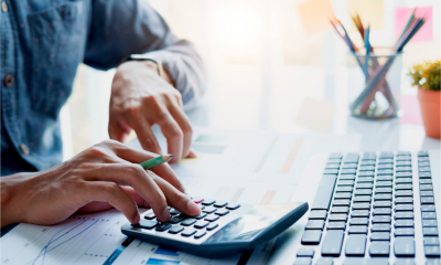 Close up of businessman working on calculator