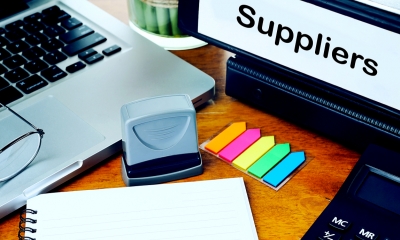 Select and negotiate with suppliers Desk with laptop, stationery and file labelled suppliers