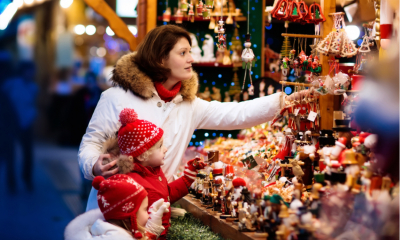 Woman and two children shopping for Christmas decorations