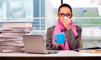 Young businesswoman sick in the office