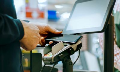 A man pays for his shopping using his smartphone