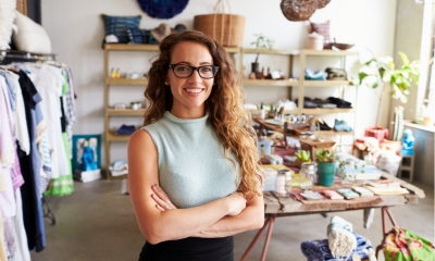 Young female business owner in a clothes shop, portrait