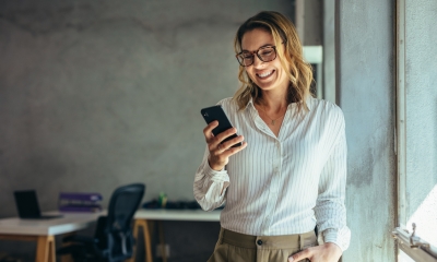 Woman wearing glasses using her mobile phone to access 4G coverage