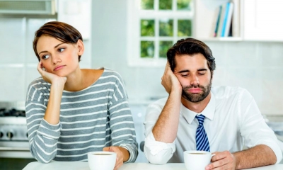 A divorced couple sitting at home together looking bored