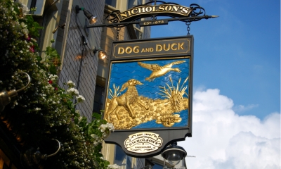 Pub sign with a blue sky backdrop