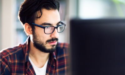 Man with glasses and red flannel shirt looks to find financial business support