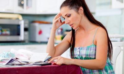 Woman sat at a desk with a calculator organising divorce and separation finances