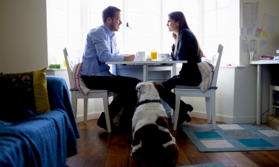 Man and woman sat down at a table having drinks