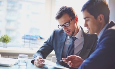 A business owner negotiates terms and goes through due diligence with a potential buyer.